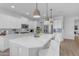 Stylish kitchen with white cabinets, stainless steel appliances, and a large island at 35701 N Bandolier Dr, San Tan Valley, AZ 85144