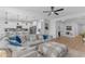Spacious living room flowing into a modern kitchen, featuring a sectional sofa and an open-concept design at 35701 N Bandolier Dr, San Tan Valley, AZ 85144