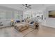 Open-concept living room connects to a modern kitchen, featuring a large sectional sofa and natural light at 35701 N Bandolier Dr, San Tan Valley, AZ 85144