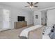 Serene main bedroom with a modern dresser, ceiling fan, and a convenient barn door for added privacy at 35701 N Bandolier Dr, San Tan Valley, AZ 85144