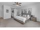 Spacious main bedroom featuring a modern bed, stylish decor, and a rustic sliding barn door at 35701 N Bandolier Dr, San Tan Valley, AZ 85144