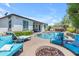 Stunning backyard oasis with a sparkling pool, cozy fire pit, and comfortable lounge seating, perfect for relaxation at 35701 N Bandolier Dr, San Tan Valley, AZ 85144