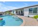 Inviting pool with step entry, lush landscaping, covered patio and ample seating creates a relaxing backyard retreat at 35701 N Bandolier Dr, San Tan Valley, AZ 85144