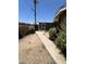 Side yard with block wall, landscaping in need of renovation and access to shed at 3701 W Keim Dr, Phoenix, AZ 85019