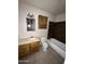 Standard bathroom featuring a single sink vanity, toilet, and a bathtub with tiled surround at 3701 W Keim Dr, Phoenix, AZ 85019
