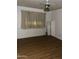 Empty bedroom with laminate flooring, ceiling fan, and window with curtains at 3701 W Keim Dr, Phoenix, AZ 85019
