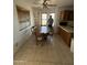 Kitchen dining area with table and chairs in need of renovation at 3701 W Keim Dr, Phoenix, AZ 85019