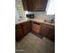 Kitchen cabinets, microwave, sink and tile flooring in need of renovation at 3701 W Keim Dr, Phoenix, AZ 85019