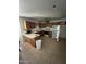 Kitchen cabinets, microwave, range, and refrigerator and tile flooring in need of renovation at 3701 W Keim Dr, Phoenix, AZ 85019