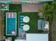 Aerial view of a backyard oasis with a sparkling pool, lounge area, lush landscaping, and shaded seating at 4036 N 40Th Pl, Phoenix, AZ 85018