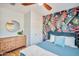 Cozy bedroom with wood floors, decorative wallpaper, dresser and a comfortable bed at 4036 N 40Th Pl, Phoenix, AZ 85018