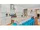 Modern kitchen featuring white cabinets, a marble island, stainless steel appliances, and stylish barstool seating at 4036 N 40Th Pl, Phoenix, AZ 85018