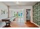 Spacious living area with hardwood floors, tropical wallpaper, and a classic shuffleboard table at 4036 N 40Th Pl, Phoenix, AZ 85018