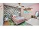 Stylish main bedroom with a wallpapered accent wall, a ceiling fan, natural light, and chic decor at 4036 N 40Th Pl, Phoenix, AZ 85018