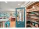Charming pantry with wood shelving, storage, and a clear view into the kitchen and dining areas at 4036 N 40Th Pl, Phoenix, AZ 85018