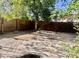 Spacious backyard featuring mature trees, a brick perimeter, and room for outdoor activities at 4104 N 113Th Ave, Phoenix, AZ 85037