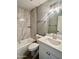 Bathroom with tub, shower, and vanity with new fixtures and tiled walls, creating a modern space at 4104 N 113Th Ave, Phoenix, AZ 85037