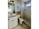 Remodeled bathroom with a modern vanity, tiled shower, and updated fixtures at 4104 N 113Th Ave, Phoenix, AZ 85037