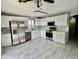 Updated kitchen featuring white cabinets, stainless steel appliances, and modern tile flooring at 4104 N 113Th Ave, Phoenix, AZ 85037