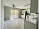 Open-concept kitchen with white cabinets, stainless steel appliances, and a view to the backyard at 4104 N 113Th Ave, Phoenix, AZ 85037