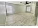 Spacious living room with tile flooring and dual windows, creating a bright interior with natural light at 4104 N 113Th Ave, Phoenix, AZ 85037