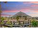 An elevated community view with palm trees and Camelback Mountain in the distance under a bright sky at 4200 N Miller Rd # 504, Scottsdale, AZ 85251