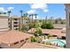Aerial view of community featuring a refreshing pool, verdant trees, and multiple amenities at 4200 N Miller Rd # 504, Scottsdale, AZ 85251