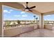 Enjoy city views from this balcony with tile flooring and decorative partition, illuminated by a ceiling fan at 4200 N Miller Rd # 504, Scottsdale, AZ 85251