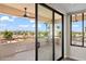 Balcony with tile floor and views of mountains and palm trees through sliding glass door at 4200 N Miller Rd # 504, Scottsdale, AZ 85251