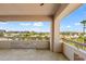 Open balcony with tile flooring and patterned dividers overlooking a serene cityscape at 4200 N Miller Rd # 504, Scottsdale, AZ 85251