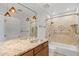Bathroom features dual sinks, granite countertops, and a shower with decorative tile accents at 4200 N Miller Rd # 504, Scottsdale, AZ 85251