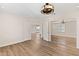 Unfurnished bedroom featuring wood-look floors, mirrored closet doors, ceiling fan and an open door at 4200 N Miller Rd # 504, Scottsdale, AZ 85251