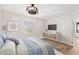 Bedroom with a ceiling fan and wood-look flooring and a large window with shutters at 4200 N Miller Rd # 504, Scottsdale, AZ 85251