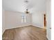 Bedroom with hardwood floors and a window with shutters at 4200 N Miller Rd # 504, Scottsdale, AZ 85251
