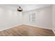 Bedroom features a ceiling fan, window shutters, and light wood floors at 4200 N Miller Rd # 504, Scottsdale, AZ 85251