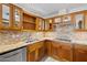 Kitchen featuring granite countertops and wooden cabinets with glass doors at 4200 N Miller Rd # 504, Scottsdale, AZ 85251