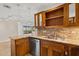 Open kitchen features granite countertops, stainless steel appliances, and a view of the lanai at 4200 N Miller Rd # 504, Scottsdale, AZ 85251