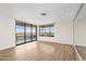 Open living area with wood floors and a sliding glass door to the balcony at 4200 N Miller Rd # 504, Scottsdale, AZ 85251