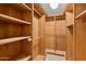 Bright walk-in closet with custom wooden shelving and ceiling light at 4200 N Miller Rd # 504, Scottsdale, AZ 85251