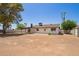 Spacious backyard features a covered patio, well-maintained lawn, and mature trees providing ample shade at 4701 N 63Rd Dr, Phoenix, AZ 85033