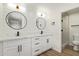 Elegant bathroom with double vanity, quartz countertops, and modern fixtures at 4701 N 63Rd Dr, Phoenix, AZ 85033