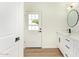 Bright bathroom featuring white cabinets with gold hardware and modern finishes at 4701 N 63Rd Dr, Phoenix, AZ 85033