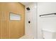 Modern bathroom featuring tiled shower, wood paneled wall and sleek fixtures at 4701 N 63Rd Dr, Phoenix, AZ 85033
