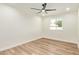 Bright bedroom with light wood flooring, a ceiling fan, and a window at 4701 N 63Rd Dr, Phoenix, AZ 85033