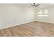Bedroom with light wood flooring, ceiling fan, fresh paint, and classic paneling at 4701 N 63Rd Dr, Phoenix, AZ 85033