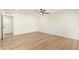 Spacious bedroom features light wood flooring, ceiling fan, and classic paneling at 4701 N 63Rd Dr, Phoenix, AZ 85033