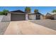 Charming exterior of the home with a driveway, two-car garage, and well-maintained landscaping at 4701 N 63Rd Dr, Phoenix, AZ 85033