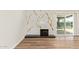 Living room featuring a modern fireplace with decorative marble-look tile at 4701 N 63Rd Dr, Phoenix, AZ 85033