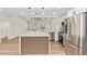 Modern kitchen features stainless steel appliances, white cabinetry and a large island at 4701 N 63Rd Dr, Phoenix, AZ 85033