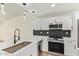 Updated kitchen features white cabinets, stainless appliances, and stylish backsplash at 4701 N 63Rd Dr, Phoenix, AZ 85033